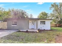 Charming single-story home with a landscaped front yard, brick accents, and a welcoming entrance at 1300 Montego Ln, Orlando, FL 32807