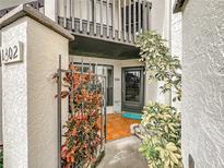 Inviting condo entrance with a decorative iron gate and beautiful landscaping at 1302 Stearman Ct # 1, Orlando, FL 32825