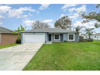 Charming single-story home featuring a well-manicured lawn, a one car garage, and a welcoming entrance at 1967 Villa Angelo Blvd, St Cloud, FL 34769