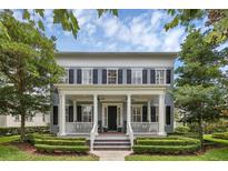 Charming two-story home with a welcoming front porch, manicured landscaping and a classic architectural style at 4533 Burke St, Orlando, FL 32814