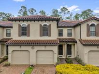 Charming townhome featuring a tile roof, well-maintained landscaping, and inviting curb appeal at 8201 Roseville Rd, Davenport, FL 33896