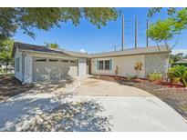 Single-story home with a stone facade, attached garage, and well maintained landscaping at 200 Melissa Ct, Sanford, FL 32773