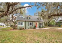 Charming single-Gathering home with a landscaped front yard and a pop of color on the front door at 201 W 16Th St, Sanford, FL 32771