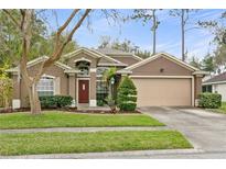 Charming single-story home with a well-manicured lawn and mature landscaping at 5477 Glen Oak Pl, Sanford, FL 32771