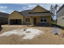 New construction home with attached garage and covered front porch at 804 Pointe Emerson Blvd, Apopka, FL 32703