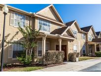 Inviting townhouse exterior featuring well-maintained landscaping and a charming entrance at 858 Grand Regency Pt # 201, Altamonte Springs, FL 32714