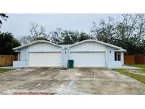 The exterior of this home features side-by-side garages and neutral toned paint at 218 Perth Ct # A, Winter Springs, FL 32708