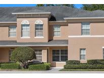 Charming townhome featuring a neutral stucco facade, well-maintained landscaping, and architectural details at 248 Carina Cir, Sanford, FL 32773