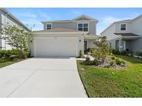 Charming two-story home with a well-manicured lawn and a two-car garage in a suburban neighborhood at 5017 Blue Hammock Ct, Kissimmee, FL 34746