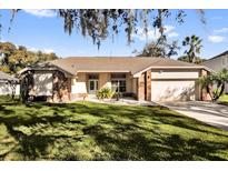 Charming single-story home with a well-manicured lawn and inviting front entrance at 7609 Sandstone Dr, Orlando, FL 32836