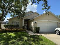 Charming one-story home with a well-maintained lawn and lush landscaping in a tranquil setting at 536 Dunoon St, Ocoee, FL 34761