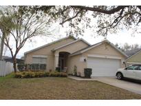 Charming single-story home with a well-maintained lawn, inviting front entrance, and an attached two-car garage at 536 Dunoon St, Ocoee, FL 34761