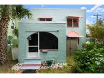 Charming exterior view of a two-story home with a unique architectural style and colorful accents at 7 Clarendon Ct, Daytona Beach, FL 32118