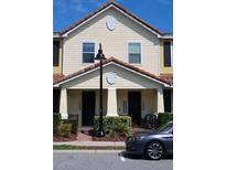 Inviting townhome exterior with manicured landscaping and a charming covered entryway at 14434 Swanley St, Orlando, FL 32832