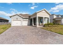 Charming single-Gathering home featuring a 2-car garage and brick paved driveway at 18441 Mowry Ct, Orlando, FL 32827