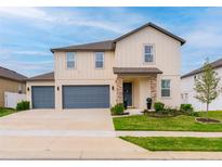 Beautiful two-story home with a two-car garage, a well-manicured lawn, and lovely landscaping at 2273 Lost Horizon Way, Clermont, FL 34715