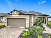 Beautiful single-story home with a well-manicured lawn and a two-car garage at 2348 Clemblue Rd, Clermont, FL 34715