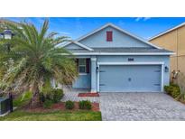 Charming single-story home featuring a well-manicured lawn, paved driveway, and attached two-car garage at 3088 Prelude Ln, Kissimmee, FL 34746