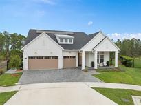 Beautiful, modern farmhouse-style home with a three-car garage and well-manicured lawn at 3135 Vanguard Ct, St Cloud, FL 34771