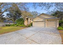 Charming front home featuring a well-manicured lawn and a spacious three-car garage at 3443 Players Point Loop, Apopka, FL 32712