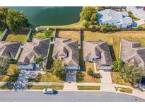 An aerial view shows the home's location on a well maintained street with a pond view at 3722 Madbury Cir, Lakeland, FL 33810