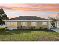 Charming single-story home featuring a well-maintained lawn and covered parking at 4431 Clubhouse Rd, Lakeland, FL 33812