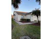 Charming home featuring manicured landscaping, a brick walkway, and a well-maintained lawn at 536 Grand Canal Dr, Kissimmee, FL 34759