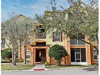 Inviting condo exterior with a covered entrance and well-maintained landscaping at 8775 Sartori St # 208, Orlando, FL 32829