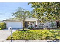 Charming single story home with white brick, an attached garage, front yard, and welcoming rocking chairs on the porch at 116 Cambridge Dr, Longwood, FL 32779
