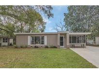 Charming single-story home with a well-maintained lawn and inviting front porch at 119 Mayfair Cir, Sanford, FL 32771