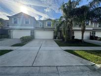Inviting townhome with well-maintained landscaping and a large driveway at 15198 Harrington Cove Dr, Orlando, FL 32824