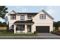 Charming two-story home with black trim, a black metal roof, and an attached garage at 2502 Bethaway Ave, Orlando, FL 32806