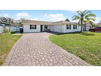 This home has a brick driveway, an attached garage, and a well manicured lawn with room to play at 3117 Shady Pine Ave, Winter Park, FL 32792