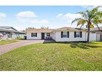 Charming single-story home with a well-maintained lawn, brick driveway, and a welcoming front porch at 3117 Shady Pine Ave, Winter Park, FL 32792