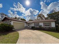 Charming single-story home featuring a well-maintained lawn, inviting driveway, and attached garage at 380 Banyan Dr, Maitland, FL 32751