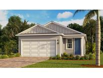 Charming single-story home featuring a two-car garage, blue front door, and lush landscaping at 3969 Kennebunk Loop, Mount Dora, FL 32757