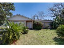 Charming single-story home with a well-maintained lawn and mature landscaping at 4155 Westgate Rd, Orlando, FL 32808