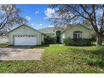 Charming single-Gathering home features a two-car garage, lush landscaping, and inviting front yard at 536 Kilimanjaro Dr, Kissimmee, FL 34758