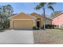 Charming single-Gathering home featuring a two-car garage and well-maintained landscaping at 1025 Sandy Ridge Dr, Davenport, FL 33896