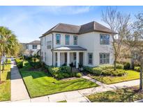 Charming two-story home with lush landscaping, inviting walkway and covered entryway at 13875 Sachs Ave, Orlando, FL 32827