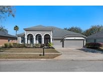 Charming single-story home featuring an attached two-car garage and well-manicured lawn at 2732 Aloma Oaks Dr, Oviedo, FL 32765