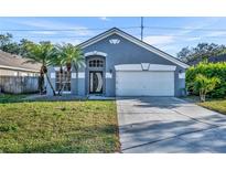 Charming single-Gathering home with a well-maintained lawn, two palm trees, and a two-car garage at 3664 Sickle St, Orlando, FL 32812