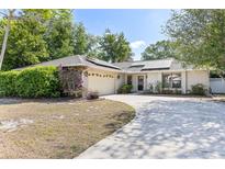 Inviting single-story home featuring a well-manicured lawn, a two-car garage, and a welcoming front entrance at 5267 Crisfield Ct, Orlando, FL 32808