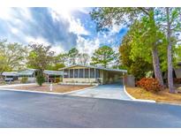 Charming single-story home featuring a screened porch and covered parking, with a well-maintained front yard at 134 E Plantation Blvd, Lake Mary, FL 32746