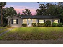 Charming single-story home with manicured lawn, black shutters, and a welcoming entrance at 1531 Norfolk Ave, Winter Park, FL 32789