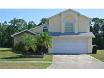 Charming two-story home with a two-car garage, a mix of brick and siding, and well-maintained landscaping at 2989 Viscount Cir, Kissimmee, FL 34747