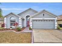 Charming single-story home showcasing a well-manicured lawn and a spacious two-car garage at 3455 Bellingham Dr, Orlando, FL 32825