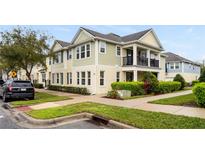 Charming two-story townhome with neutral tones, manicured landscaping and welcoming front porch at 465 Gee Hammock Ln, Winter Springs, FL 32708