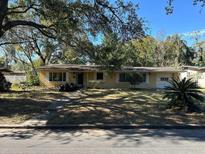 Charming one-story home with a cozy front yard and lush trees creating a pleasant, shaded view at 506 N Rio Grande Ave, Orlando, FL 32805