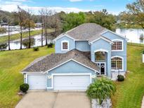 Stunning two-story home with water view, three-car garage, and beautifully landscaped yard at 105 Norris Pl, Casselberry, FL 32707